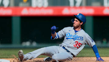 Apr 1, 2021; Denver, Colorado, USA; Los Angeles Dodgers center fielder Cody Bellinger (35) slides safely in to second on a double in the fifth inning against the Colorado Rockies at Coors Field. Mandatory Credit: Isaiah J. Downing-USA TODAY Sports
