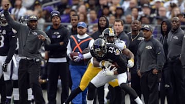 Dec 27, 2015; Baltimore, MD, USA; Baltimore Ravens cornerback Jimmy Smith (22) intercepts Pittsburgh Steelers quarterback Ben Roethlisberger (7) (not pictured) pass intended for wide receiver Antonio Brown (84) during the fourth quarter at M&T Bank Stadium. Baltimore Ravens defeated Pittsburgh Steelers 20-17. Mandatory Credit: Tommy Gilligan-USA TODAY Sports