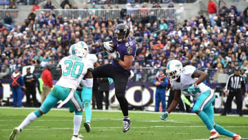 Dec 4, 2016; Baltimore, MD, USA; Baltimore Ravens tight end Dennis Pitta (88) catches pass for a touchdown from quarterback Joe Flacco (not pictured) in front of Miami Dolphins free safety Bacarri Rambo (30) and linebacker Spencer Paysinger (42) during the first quarter at M&T Bank Stadium. Mandatory Credit: Tommy Gilligan-USA TODAY Sports
