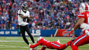 ORCHARD PARK, NY - DECEMBER 8: Trent Murphy #93 of the Buffalo Bills dives to try and make a tackle on Lamar Jackson #8 of the Baltimore Ravens as he throws a pass during the second half at New Era Field on December 8, 2019 in Orchard Park, New York. Baltimore beats Buffalo 24 to 17. (Photo by Timothy T Ludwig/Getty Images)