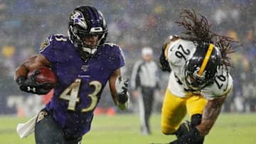 BALTIMORE, MARYLAND - DECEMBER 29: Running back Justice Hill #43 of the Baltimore Ravens rushes past inside linebacker Mark Barron #26 of the Pittsburgh Steelers during the second quarter at M&T Bank Stadium on December 29, 2019 in Baltimore, Maryland. (Photo by Scott Taetsch/Getty Images)