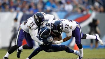 NASHVILLE, TN - OCTOBER 14: Corey Davis #84 of the Tennessee Titans is tackled by Eric Weddle #32 of the Baltimore Ravens and Jimmy Smith #22 during the third quarter at Nissan Stadium on October 14, 2018 in Nashville, Tennessee. (Photo by Joe Robbins/Getty Images)