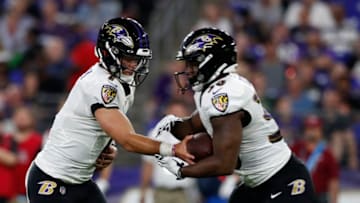BALTIMORE, MARYLAND - AUGUST 15: Trace McSorley #7 of the Baltimore Ravens hands the ball off to Kenneth Dixon #30 in the first half of a preseason game against the Green Bay Packers at M&T Bank Stadium on August 15, 2019 in Baltimore, Maryland. (Photo by Todd Olszewski/Getty Images)