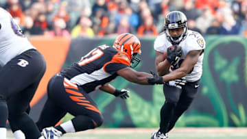 CINCINNATI, OH - JANUARY 1: Kenneth Dixon #30 of the Baltimore Ravens breaks an attempted tackle by Geno Atkins #97 of the Cincinnati Bengals during the third quarter at Paul Brown Stadium on January 1, 2017 in Cincinnati, Ohio. (Photo by Michael Hickey/Getty Images)