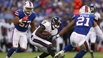 BALTIMORE, MD - AUGUST 26: Running back Taquan Mizzell #33 of the Baltimore Ravens rushes in front of free safety Jordan Poyer #21 of the Buffalo Bills in the first half during a preseason game at M&T Bank Stadium on August 26, 2017 in Baltimore, Maryland. (Photo by Patrick Smith/Getty Images)
