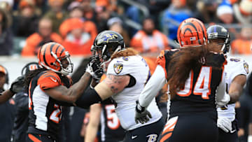 CINCINNATI, OH - JANUARY 3: Cornerback Adam Jones #24 of the Cincinnati Bengals grabs the face mask of center Ryan Jensen #66 of the Baltimore Ravens during the first quarter at Paul Brown Stadium on January 3, 2016 in Cincinnati, Ohio. (Photo by Andrew Weber/Getty Images)