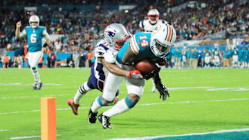 MIAMI GARDENS, FL - DECEMBER 11: Jarvis Landry #14 of the Miami Dolphins scores a touchdown in the second quarter against the defense of Jonathan Jones #31 of the New England Patriots at Hard Rock Stadium on December 11, 2017 in Miami Gardens, Florida. (Photo by Mike Ehrmann/Getty Images)