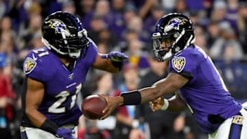 BALTIMORE, MARYLAND - JANUARY 11: Lamar Jackson #8 of the Baltimore Ravens hands the ball off to Mark Ingram #21 against the Tennessee Titans during the AFC Divisional Playoff game at M&T Bank Stadium on January 11, 2020 in Baltimore, Maryland. (Photo by Will Newton/Getty Images)