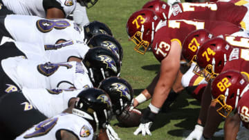 LANDOVER, MARYLAND - OCTOBER 04: Center Chase Roullier #73 of the Washington Football Team snaps the ball against the Baltimore Ravens during the first half at FedExField on October 4, 2020 in Landover, Maryland. Due to the coronavirus pandemic, the Washington Football Team did not host fans during the game. (Photo by Patrick Smith/Getty Images)