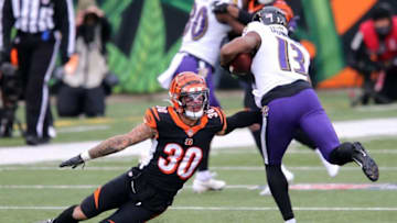 Baltimore Ravens wide receiver Devin Duvernay (13) breaks a tackle by Cincinnati Bengals free safety Jessie Bates (30) in the first quarter during a Week 17 NFL football game, Sunday, Jan. 3, 2021, at Paul Brown Stadium in Cincinnati.Baltimore Ravens At Cincinnati Bengals Week 17 Jan 3