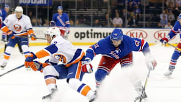 Sep 27, 2016; New York, NY, USA; New York Rangers center Maxim Lapierre (41) and New York Islanders defenseman Travis Hamonic (3) battle for position during the first period during a preseason hockey game at Madison Square Garden. Mandatory Credit: Andy Marlin-USA TODAY Sports