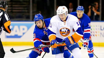 Sep 27, 2016; New York, NY, USA; New York Rangers center Mika Zibanejad (93) and New York Islanders center Mathew Barzal (13) battle for a loose puck during the first period during a preseason hockey game at Madison Square Garden. Mandatory Credit: Andy Marlin-USA TODAY Sports