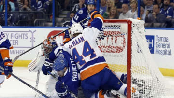 Nov 10, 2016; Tampa, FL, USA; Tampa Bay Lightning center Cedric Paquette (13) falls into the net as New York Islanders goalie Jaroslav Halak (41) defends and defenseman Calvin de Haan (44) is called for interference on the play during the second period at Amalie Arena. Mandatory Credit: Kim Klement-USA TODAY Sports
