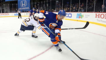 Dec 23, 2016; Brooklyn, NY, USA; New York Islanders defenseman Calvin de Haan (44) controls the puck against Buffalo Sabres left wing Johan Larsson (22) during the third period at Barclays Center. Mandatory Credit: Brad Penner-USA TODAY Sports