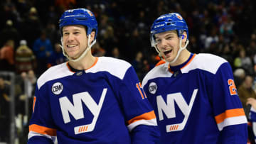 NEW YORK, NEW YORK - JANUARY 15: Matt Martin #17 and Scott Mayfield #24 of the New York Islanders react after a 2-1 win in overtime against the St. Louis Blues at Barclays Center on January 15, 2019 in the Brooklyn borough of New York City. (Photo by Sarah Stier/Getty Images)
