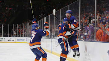 UNIONDALE, NEW YORK - APRIL 10: (l-r) Adam Pelech #3 and Josh Bailey #12 of the New York Islanders celebrate Bailey's game winning overtime goal against the Pittsburgh Penguins in Game One of the Eastern Conference First Round during the 2019 NHL Stanley Cup Playoffs at NYCB Live's Nassau Coliseum on April 10, 2019 in Uniondale, New York. The Islanders defeated the Penguins 4-3 in overtime. (Photo by Bruce Bennett/Getty Images)