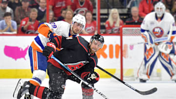 RALEIGH, NORTH CAROLINA - MAY 01: Brock Nelson #29 of the New York Islanders and Calvin de Haan #44 of the Carolina Hurricanes battle for a loose puck during the third period of Game Three of the Eastern Conference Second Round during the 2019 NHL Stanley Cup Playoffs at PNC Arena on May 01, 2019 in Raleigh, North Carolina. The Hurricanes won 5-2. (Photo by Grant Halverson/Getty Images)