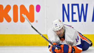 RALEIGH, NORTH CAROLINA - MAY 03: Tom Kuhnhackl #14 of the New York Islanders lays on the ice after being hit by a teammates stick against the Carolina Hurricanes in the third period of Game Four of the Eastern Conference Second Round during the 2019 NHL Stanley Cup Playoffs at PNC Arena on May 03, 2019 in Raleigh, North Carolina. The Hurricanes won 5-2 and won the series, 4-0. (Photo by Grant Halverson/Getty Images)