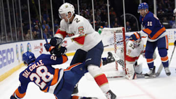 UNIONDALE, NEW YORK - OCTOBER 12: Josh Brown #2 of the Florida Panthers checks Michael Dal Colle #28 of the New York Islanders during the second period at NYCB Live's Nassau Coliseum on October 12, 2019 in Uniondale, New York. (Photo by Bruce Bennett/Getty Images)