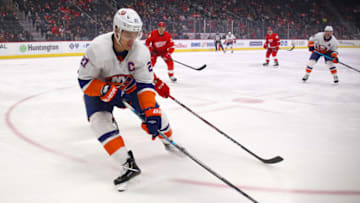DETROIT, MICHIGAN - DECEMBER 02: Anders Lee #27 of the New York Islanders looks to control the puck in the first period while playing the Detroit Red Wings at Little Caesars Arena on December 02, 2019 in Detroit, Michigan. (Photo by Gregory Shamus/Getty Images)