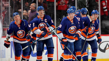 NEWARK, NEW JERSEY - JANUARY 07: Anders Lee #27 of the New York Islanders and the rest of his teammates celebrate the overtime win over the New Jersey Devils at Prudential Center on January 07, 2020 in Newark, New Jersey.The New York Islanders defeated the New Jersey Devils 4-3 in overtime. (Photo by Elsa/Getty Images)