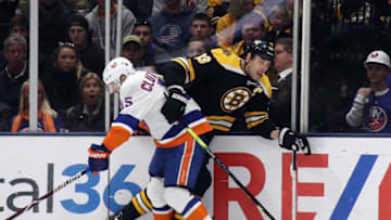 UNIONDALE, NEW YORK - FEBRUARY 29: Cal Clutterbuck #15 of the New York Islanders checks Zdeno Chara #33 of the Boston Bruins into the boards during the third period at NYCB Live's Nassau Coliseum on February 29, 2020 in Uniondale, New York. The Bruins shut-out the Islanders 4-0. (Photo by Bruce Bennett/Getty Images)