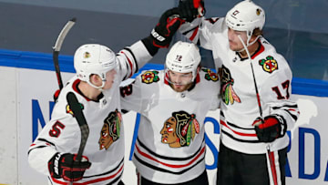 EDMONTON, ALBERTA - AUGUST 13: Dylan Strome #17 of the Chicago Blackhawks celebrates his goal at 19:46 of the second period against the Vegas Golden Knights and is joined by Connor Murphy #5 and Alex DeBrincat #12 in Game Two of the Western Conference First Round during the 2020 NHL Stanley Cup Playoffs at Rogers Place on August 13, 2020 in Edmonton, Alberta, Canada. (Photo by Jeff Vinnick/Getty Images)