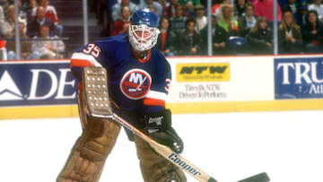 LANDOVER, MD - MARCH 20: Glenn Healy #35 of the New York Islanders clears the puck during a NHL hockey game against the Washington Capitals on March 20, 1990 at the Capital Centre in Landover, Maryland. (Photo by Mitchell Layton/Getty Images)