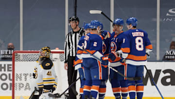 UNIONDALE, NEW YORK - FEBRUARY 25: The New York Islanders celebrate a goal by Anders Lee #27 (2nd from right) at 14:44 of the third period against Jaroslav Halak #41 of the Boston Bruins at Nassau Coliseum on February 25, 2021 in Uniondale, New York. (Photo by Bruce Bennett/Getty Images)