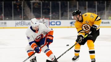 BOSTON, MASSACHUSETTS - APRIL 15: Patrice Bergeron #37 of the Boston Bruins defends Oliver Wahlstrom #26 of the New York Islanders during the second period at TD Garden on April 15, 2021 in Boston, Massachusetts. (Photo by Maddie Meyer/Getty Images)
