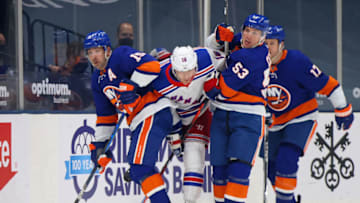 UNIONDALE, NEW YORK - MAY 01: Cal Clutterbuck #15 and Casey Cizikas #53 of the New York Islanders hold back Ryan Strome #16 of the New York Rangers during the first period at the Nassau Coliseum on May 01, 2021 in Uniondale, New York. (Photo by Bruce Bennett/Getty Images)