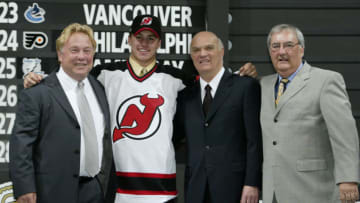 NASHVILLE, TN - JUNE 21: (L to R) David Conte, first round draft pick (#17 overall) Zach Parise, Lou Lamoriello and Claude Carrier of the New Jersey Devils pose for a portrait on stage during the 2003 NHL Entry Draft at the Gaylord Entertainment Center on June 21, 2003 in Nashville, Tennessee. (Photo by Elsa/Getty Images/NHLI)