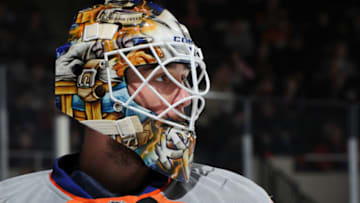 UNIONDALE, NY - JANUARY 25: Kevin Poulin #60 of the New York Islanders looks on during the game against the St. Louis Blues at Nassau Coliseum on January 25, 2014 in Uniondale, New York. (Photo by Christopher Pasatieri/Getty Images)