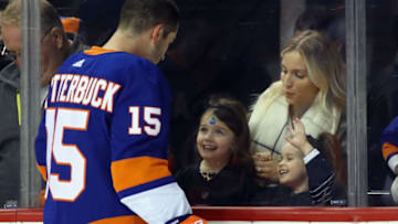 NEW YORK, NY - DECEMBER 23: Cal Clutterbuck #15 of the New York Islanders looks at his family during warm ups prior to the game against the Winnipeg Jets at the Barclays Center on December 23, 2017 in the Brooklyn borough of New York City. (Photo by Bruce Bennett/Getty Images)