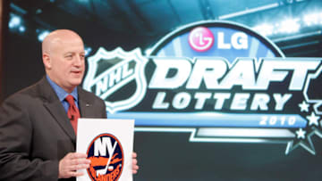 Deputy Commissioner of the NHL Bill Daly announces the fifth pick to go to the New York Islanders (Photo by Abelimages / Getty Images for NHL)