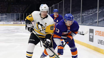 UNIONDALE, NEW YORK - FEBRUARY 06: Sidney Crosby #87 of the Pittsburgh Penguins skates against Mathew Barzal #13 of the New York Islanders at the Nassau Coliseum on February 06, 2021 in Uniondale, New York. (Photo by Bruce Bennett/Getty Images)