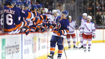 NEW YORK, NY - FEBRUARY 15: Thomas Hickey #14 of the New York Islanders celebrates with teammates after scoring a goal against the New York Rangers during their game at Barclays Center on February 15, 2018 in the Brooklyn borough of New York City. (Photo by Abbie Parr/Getty Images)