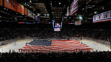 UNIONDALE, NY - OCTOBER 03: A large American Flag is carried on the ice for the National Anthem during festivities before the home opener NHL hockey game betwen the New York Islanders and the Pittsburgh Penguins on October 3, 2009 at the Nassau Coliseum in Uniondale, New York. The Penguins defeated the Islanders 4-3 in shootout overtime. (Photo by Paul Bereswill/Getty Images)