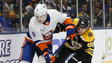 Feb 29, 2020; Uniondale, New York, USA; New York Islanders defenseman Ryan Pulock (6) and Boston Bruins right wing David Pastrnak (88) battle for position during the first period at Nassau Veterans Memorial Coliseum. Mandatory Credit: Andy Marlin-USA TODAY Sports