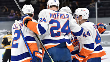Mar 25, 2021; Boston, Massachusetts, USA; New York Islanders defenseman Nick Leddy (2) defenseman Scott Mayfield (24) celebrate a goal by center Jean-Gabriel Pageau (44) during the second period against the Boston Bruins at TD Garden. Mandatory Credit: Bob DeChiara-USA TODAY Sports