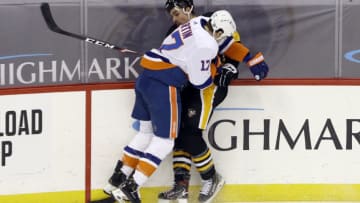 Feb 18, 2021; Pittsburgh, Pennsylvania, USA; New York Islanders left wing Matt Martin (17) checks Pittsburgh Penguins defenseman Cody Ceci (4) during the third period at PPG Paints Arena. Pittsburgh won 4-1. Mandatory Credit: Charles LeClaire-USA TODAY Sports