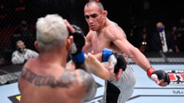 LAS VEGAS, NEVADA - DECEMBER 12: (R-L) Tony Ferguson kicks Charles Oliveira of Brazil in their lightweight bout during the UFC 256 event at UFC APEX on December 12, 2020 in Las Vegas, Nevada. (Photo by Jeff Bottari/Zuffa LLC)