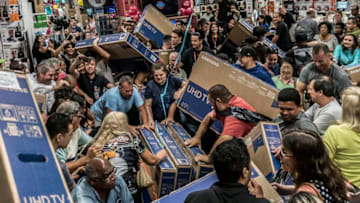 People participate in a "Black Friday" event in São Paulo, Brazil, on November 23, 2018. "Black Friday" is a term created in the United States to cite the day of big business that is celebrated the next day from Action Thanks, and that in Brazil began to happen in 2010. (Photo by Cris Faga/NurPhoto via Getty Images)