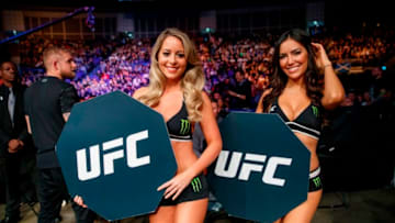 UFC (Ultimate Fighting Championship) Octagon Girls pose for a photograph during a UFC fight at the O2 Arena in London on March 17, 2018.Accused of promoting an ultra-violent spectacle by allowing strikes on an opponent on the ground, the organization has put in place protocols to secure the health of athletes, including monitoring the impact on the brain of blows to the head. / AFP PHOTO / Tolga Akmen (Photo credit should read TOLGA AKMEN/AFP via Getty Images)