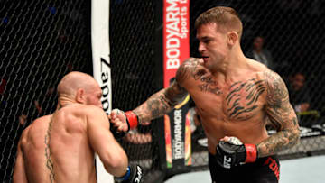 ABU DHABI, UNITED ARAB EMIRATES - JANUARY 23: In this handout image provided by the UFC, (R-L) Dustin Poirier punches Conor McGregor of Ireland in a lightweight fight during the UFC 257 event inside Etihad Arena on UFC Fight Island on January 23, 2021 in Abu Dhabi, United Arab Emirates. (Photo by Jeff Bottari/Zuffa LLC via Getty Images)