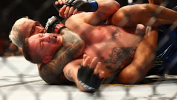 May 7, 2022; Phoenix, Arizona, USA; Charles Oliveira applies a hold for the submission victory against Justin Gaethje during UFC 274 at Footprint Center. Mandatory Credit: Mark J. Rebilas-USA TODAY Sports