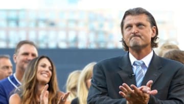 Aug 30, 2014; San Diego, CA, USA; San Diego Padres former closer Trevor Hoffman acknowledges the crowd during his Padres Hall of Fame induction ceremony as his wife Tracy (left, background) looks on before the game against the Los Angeles Dodgers at Petco Park. Mandatory Credit: Jake Roth-USA TODAY Sports