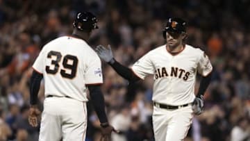 Sep 30, 2015; San Francisco, CA, USA; San Francisco Giants second baseman Nick Noonan (21) celebrates with third base coach Roberto Kelly (39) after hitting a home run against the Los Angeles Dodgers during the seventh inning at AT&T Park. The San Francisco Giants defeated the Los Angeles Dodgers 5-0. Mandatory Credit: Ed Szczepanski-USA TODAY Sports