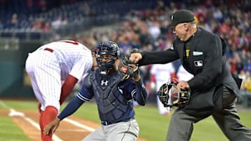 Apr 13, 2016; Philadelphia, PA, USA; San Diego Padres catcher Christian Bethancourt (12) holds up the ball as umpire Lance Barksdale (23) calls out Philadelphia Phillies right fielder Peter Bourjos (17) at home during fourth inning at Citizens Bank Park. The Phillies defeated the Padres, 2-1. Mandatory Credit: Eric Hartline-USA TODAY Sports