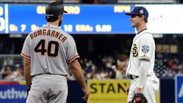 May 17, 2016; San Diego, CA, USA; San Diego Padres first baseman Wil Myers (4) and San Francisco Giants starting pitcher Madison Bumgarner (40) talk during the ninth inning after Bumgarner reached first on a walk at Petco Park. Mandatory Credit: Jake Roth-USA TODAY Sports
